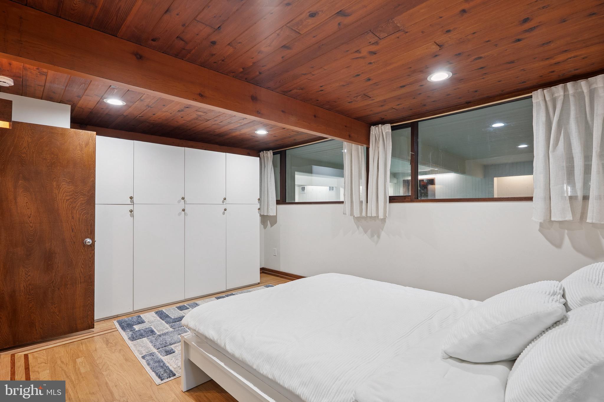 11428 Purple Beech Drive Reston, VA 20191 - Photo 25 of 52 a bedroom with a bed and a large window