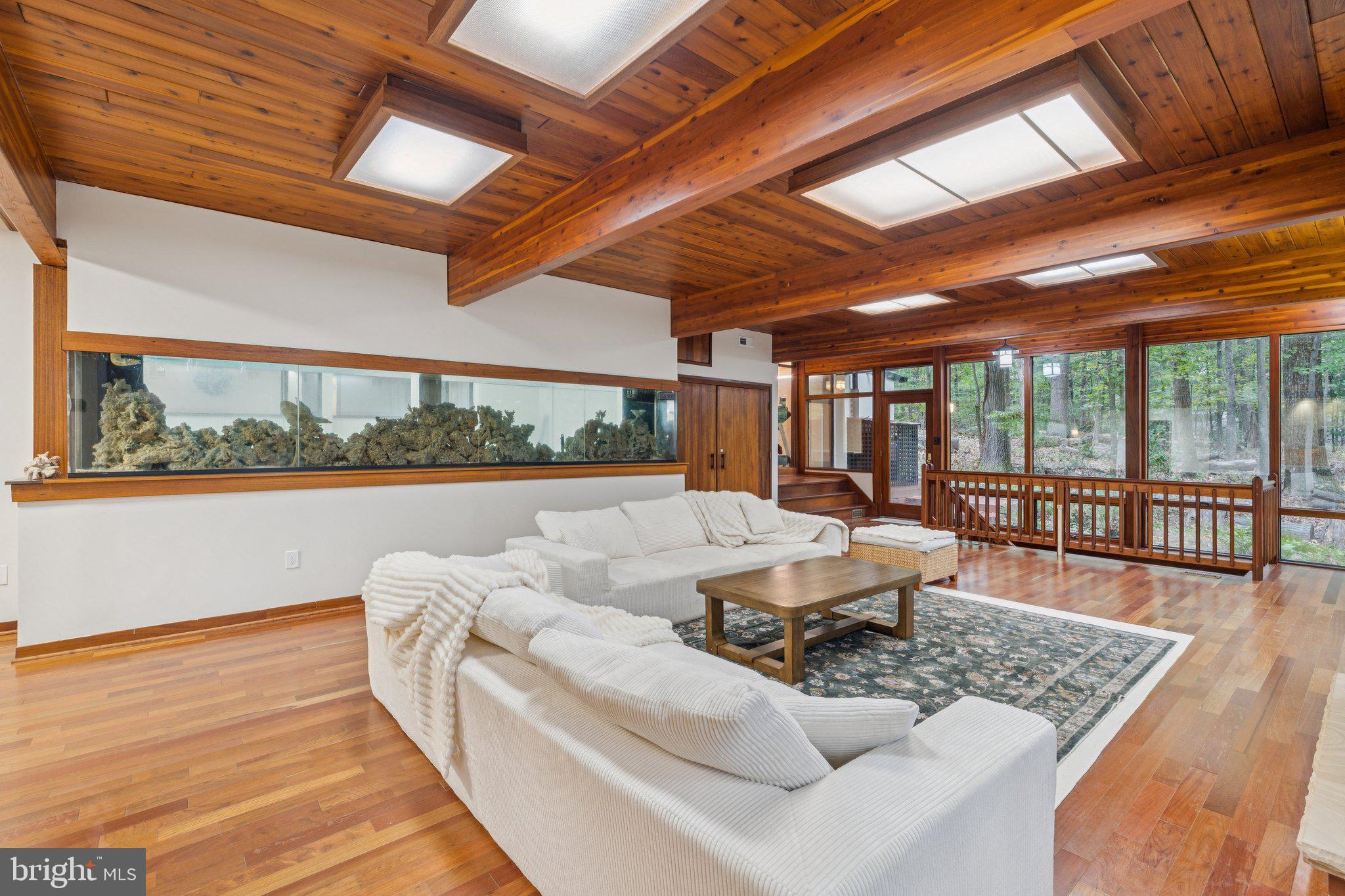 11428 Purple Beech Drive Reston, VA 20191 - Photo 38 of 52 a living room with furniture floor to ceiling window and wooden floor