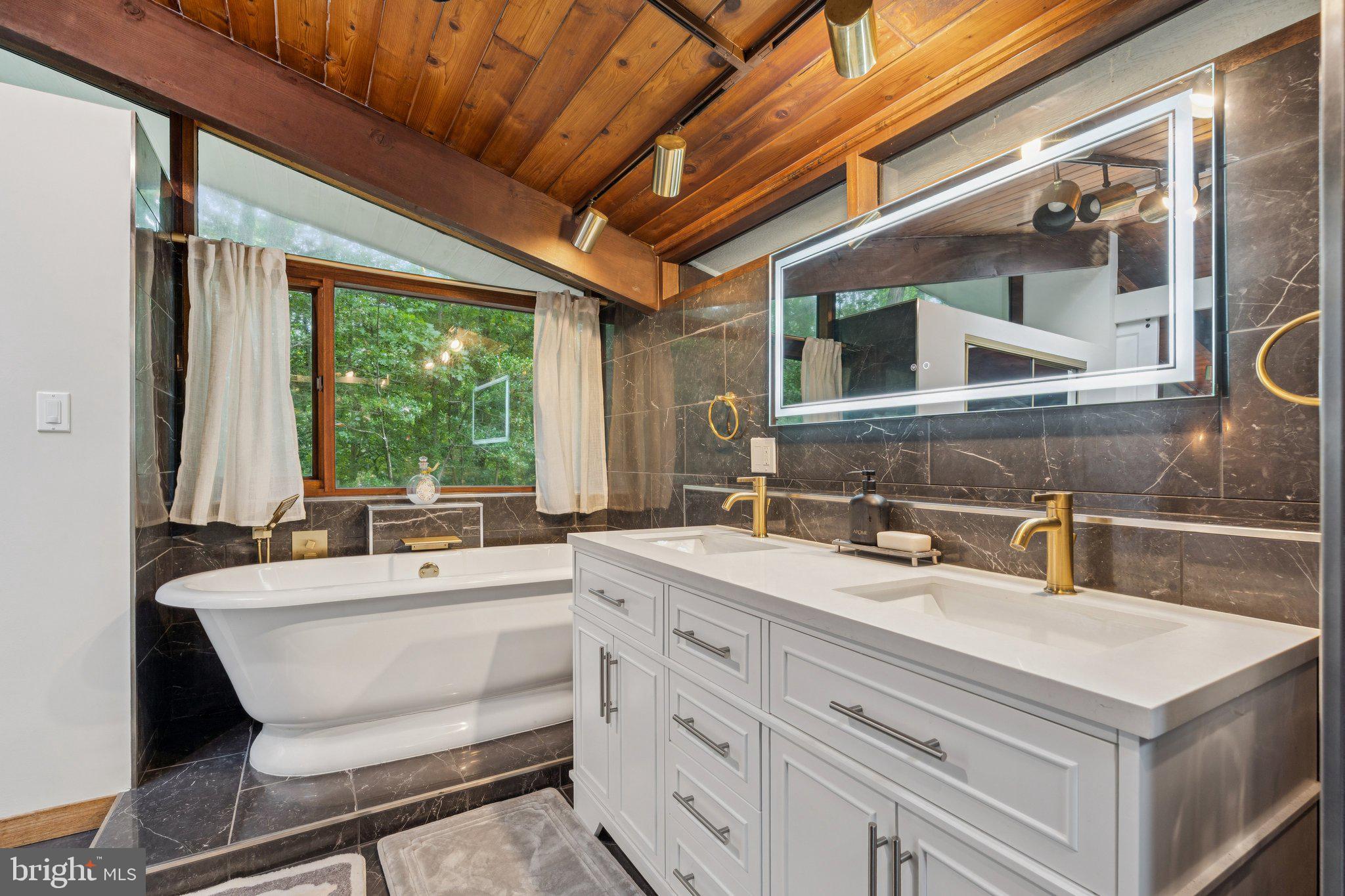 11428 Purple Beech Drive Reston, VA 20191 - Photo 43 of 52 a bathroom with a double vanity sink and a window
