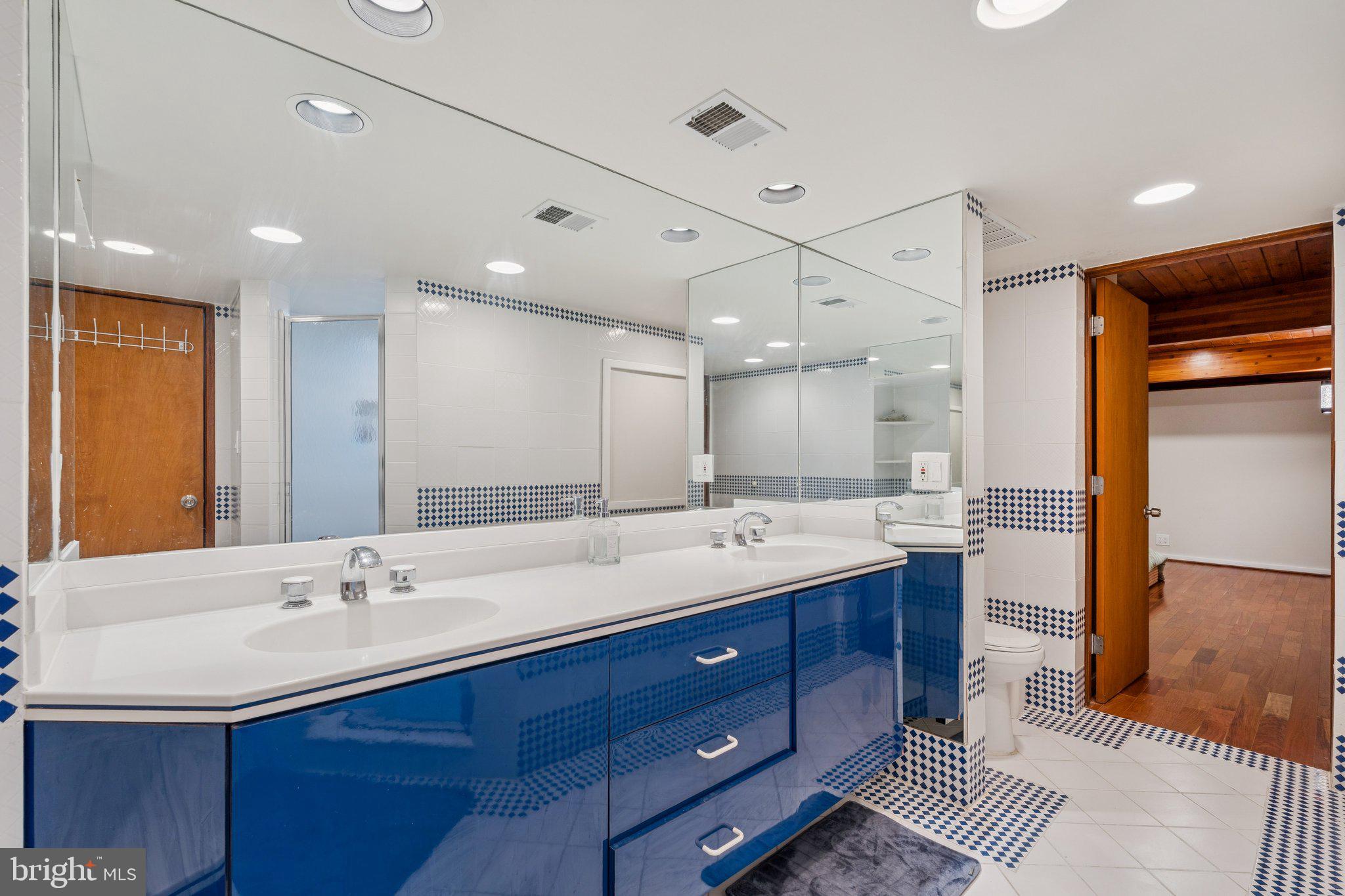 11428 Purple Beech Drive Reston, VA 20191 - Photo 46 of 52 a bathroom with double vanity sinks and a mirror