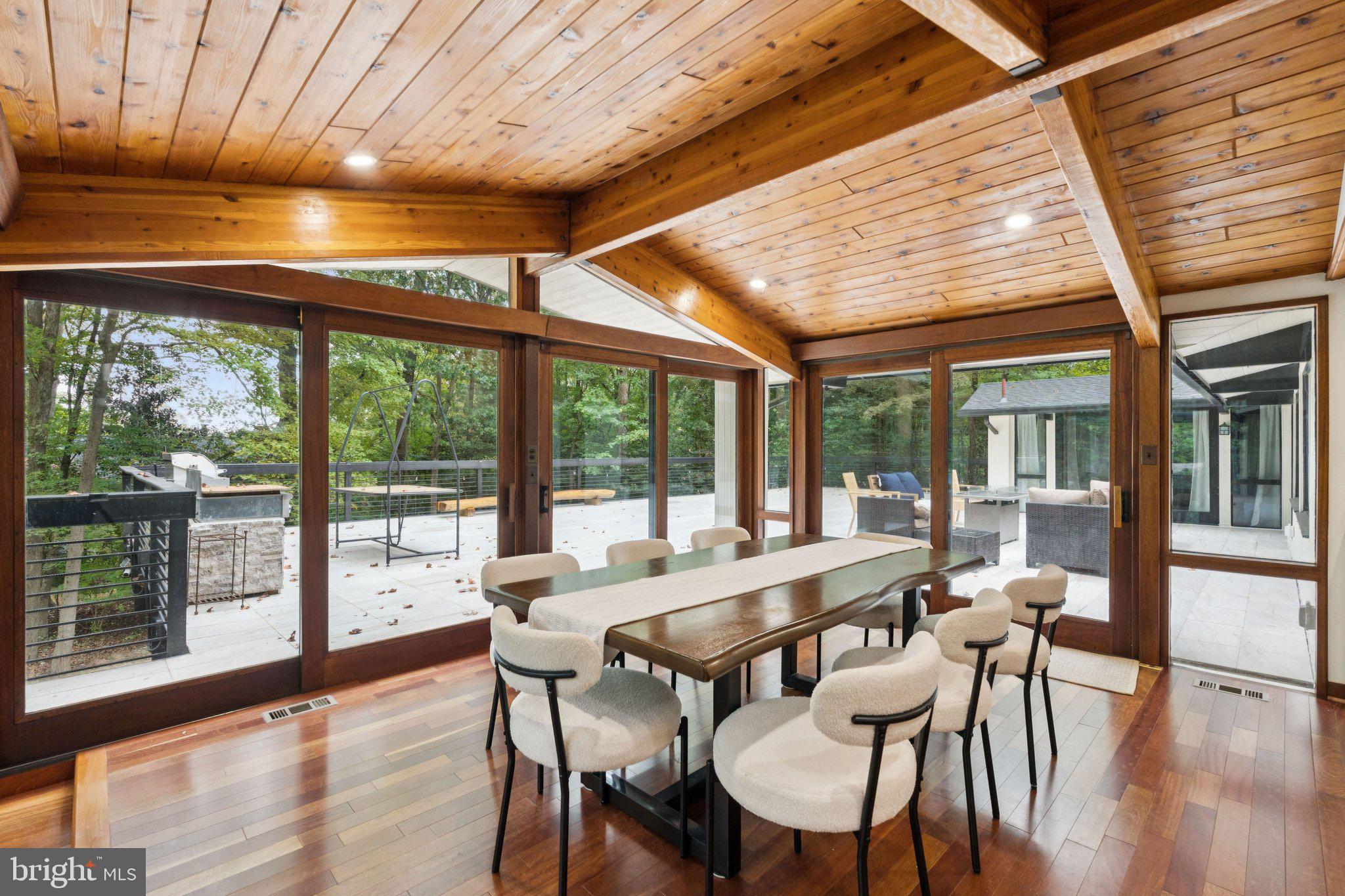 11428 Purple Beech Drive Reston, VA 20191 - Photo 9 of 52 a view of a dining room with furniture large windows and wooden floor