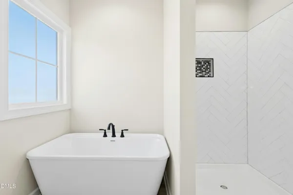a white tub sitting in a bathroom