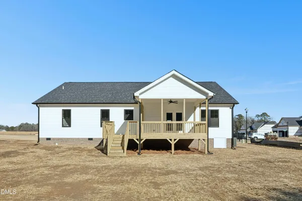 a view of a white house with a yard