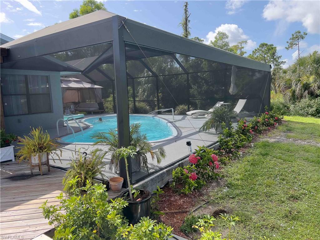 3220 63rd Street Southwest Naples, FL 34105 - Photo 18 of 36 Swimming pool with a deck, a lanai, and a patio area