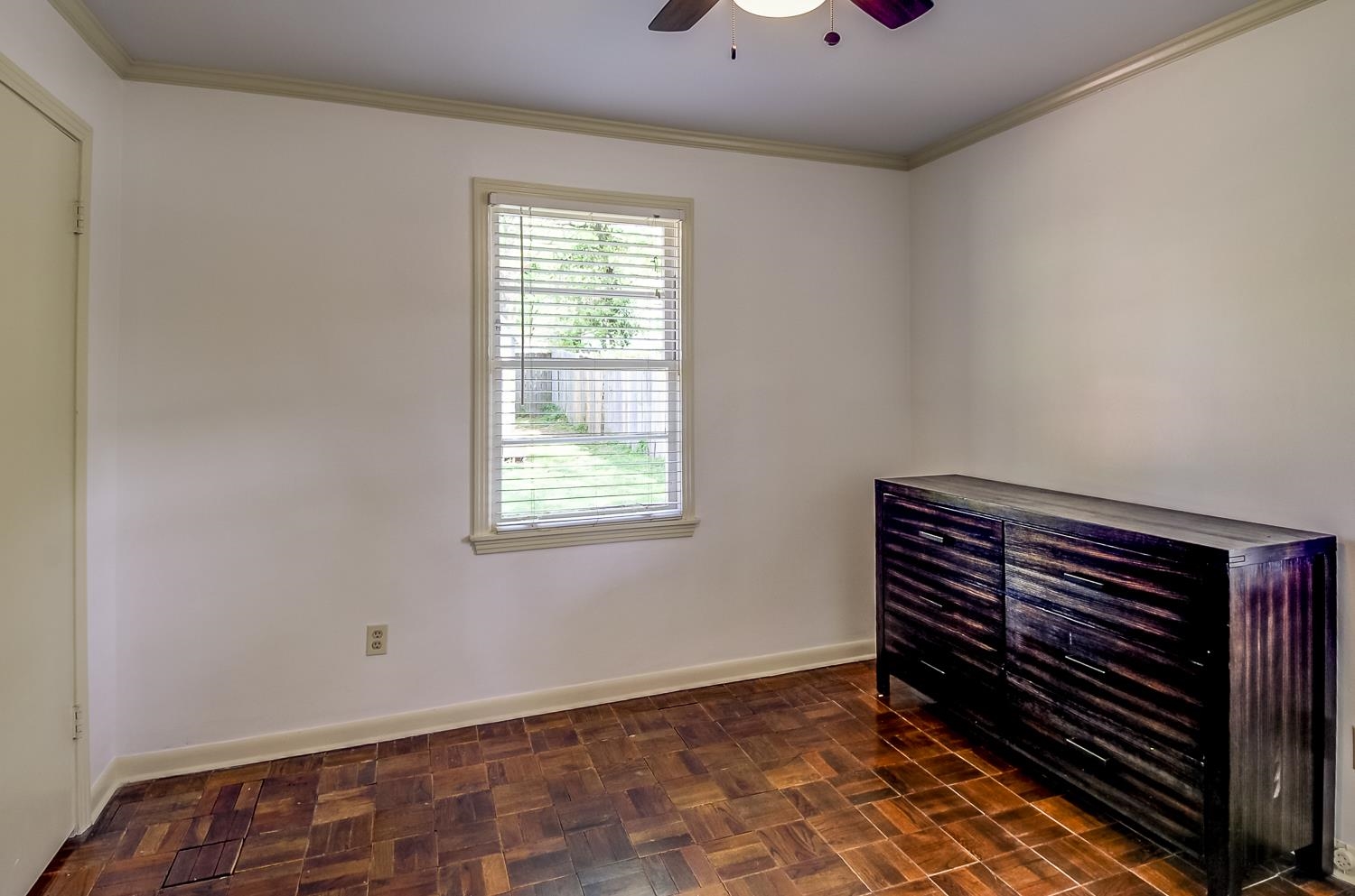 5056 Wingdale Road Memphis, TN 38117 - Photo 15 of 18 Unfurnished bedroom with crown molding, parquet floors, and a ceiling fan