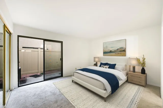 a bedroom with a bed and a painting