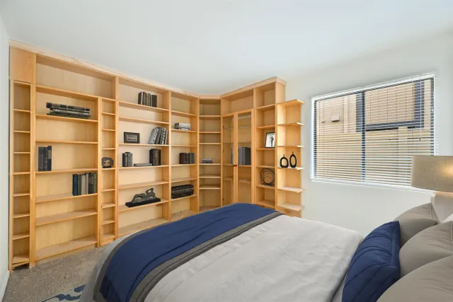 a bedroom with a bed and a window