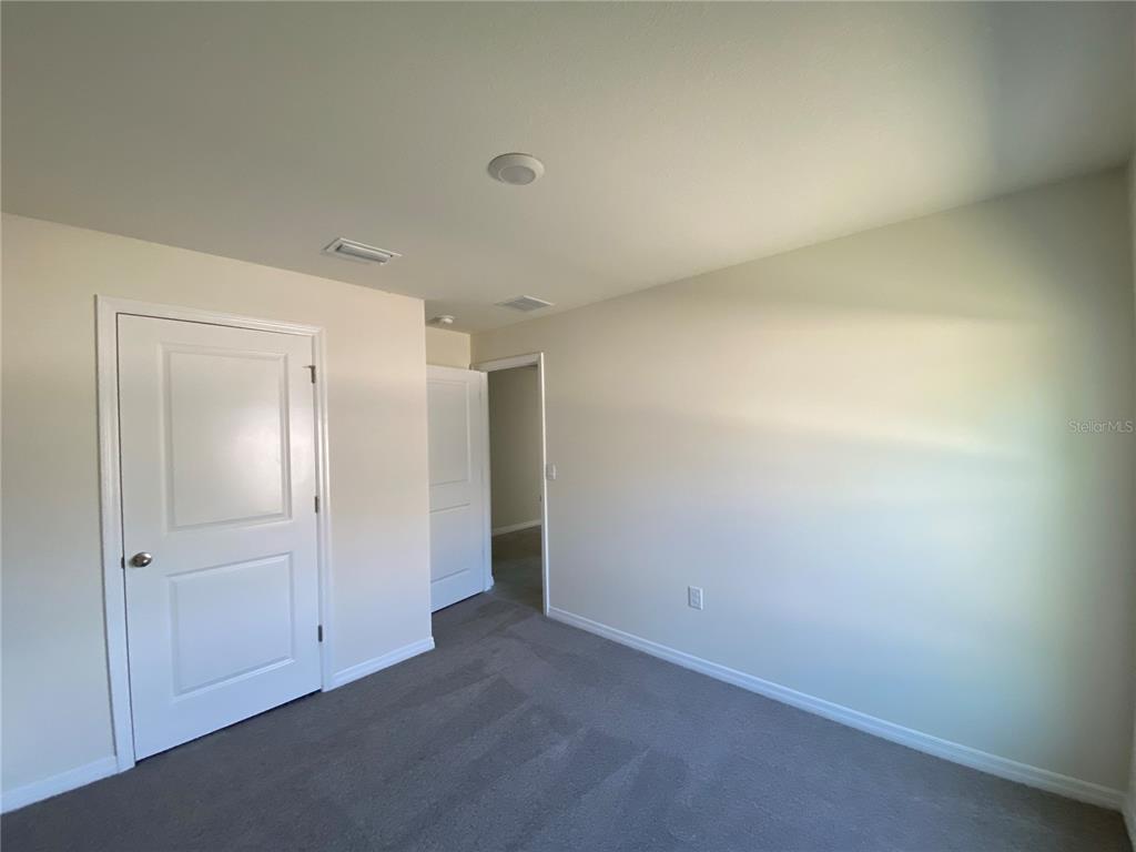 492 Hickory Course Loop Ocala, FL 34472 - Photo 14 of 28 an empty room with closet area