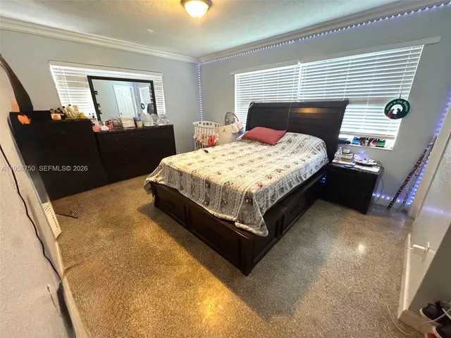 a bedroom with a bed and dresser with mirror