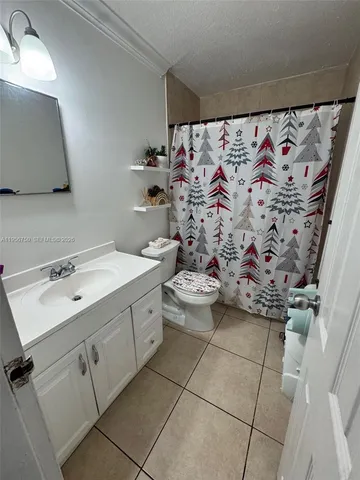 a bathroom with a sink mirror vanity and toilet