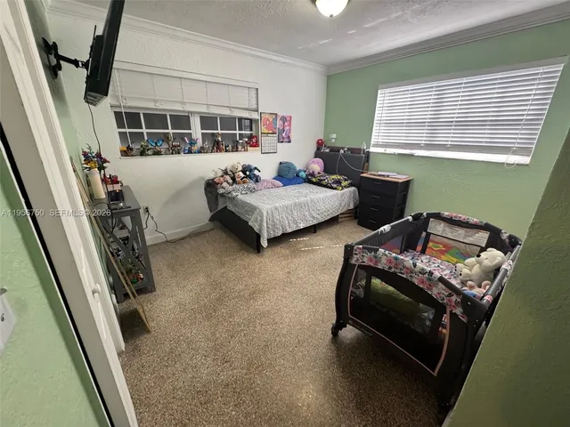 a bedroom with furniture and a window