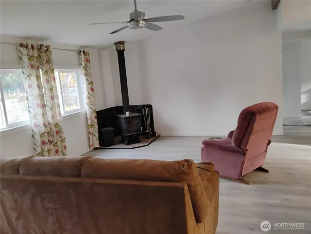 a kitchen with stainless steel appliances a dining table chairs refrigerator and sink