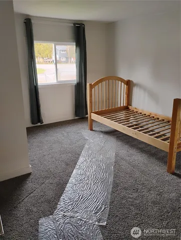 a bathroom with a granite countertop toilet and a shower