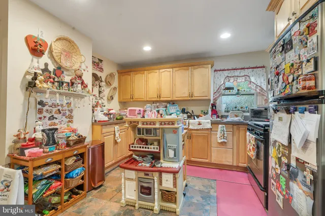 a kitchen with stainless steel appliances a stove a sink and a refrigerator