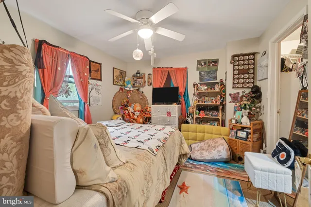 a bedroom with a bed furniture and a flat screen tv