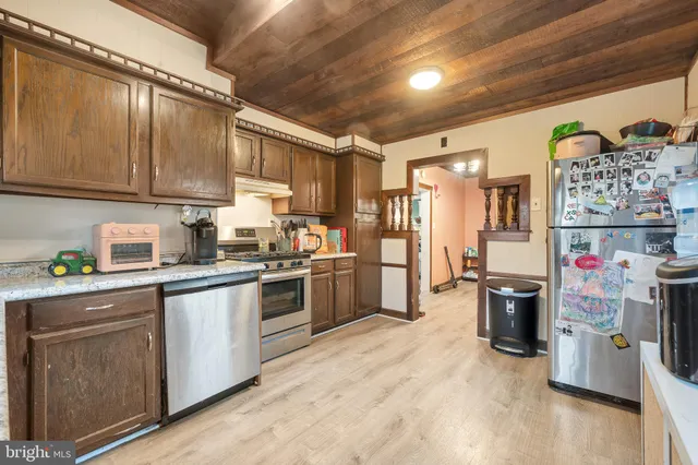 a kitchen with refrigerator and cabinets