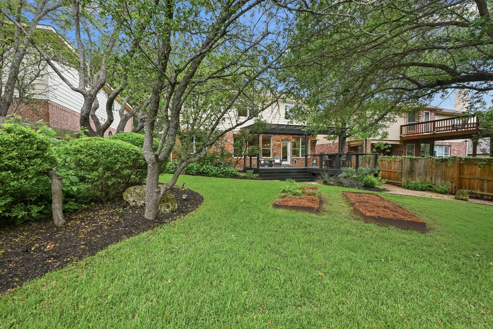 2823 Lantana Ridge Drive Austin, TX 78732 - Photo 32 of 34 a view of an house with backyard space and balcony