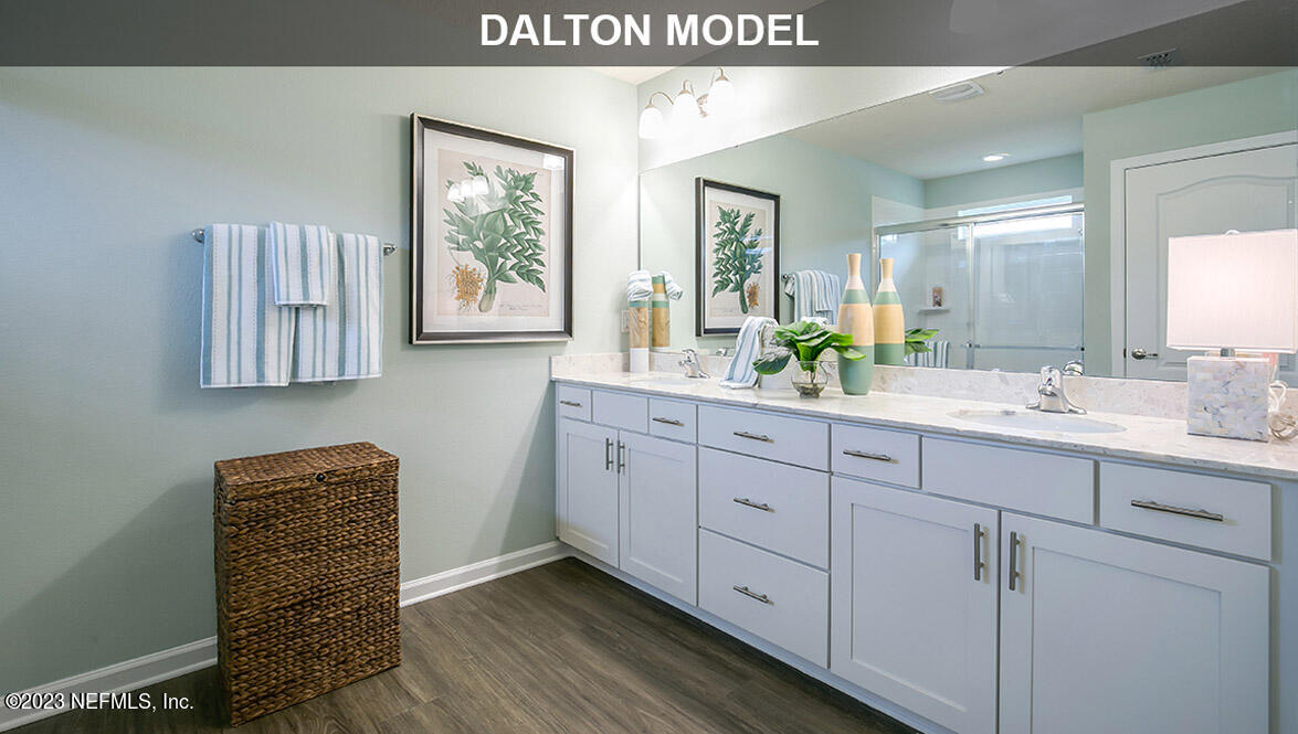 65792 Edgewater Drive Yulee, FL 32097 - Photo 11 of 45 a spacious bathroom with a double vanity sink and a window