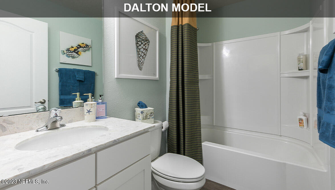 65792 Edgewater Drive Yulee, FL 32097 - Photo 14 of 45 a bathroom with a sink a toilet and shower