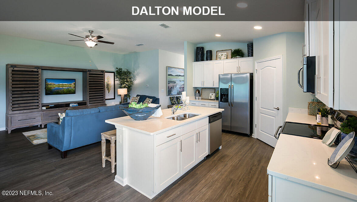65792 Edgewater Drive Yulee, FL 32097 - Photo 5 of 45 a view of living room kitchen with furniture and flat screen tv