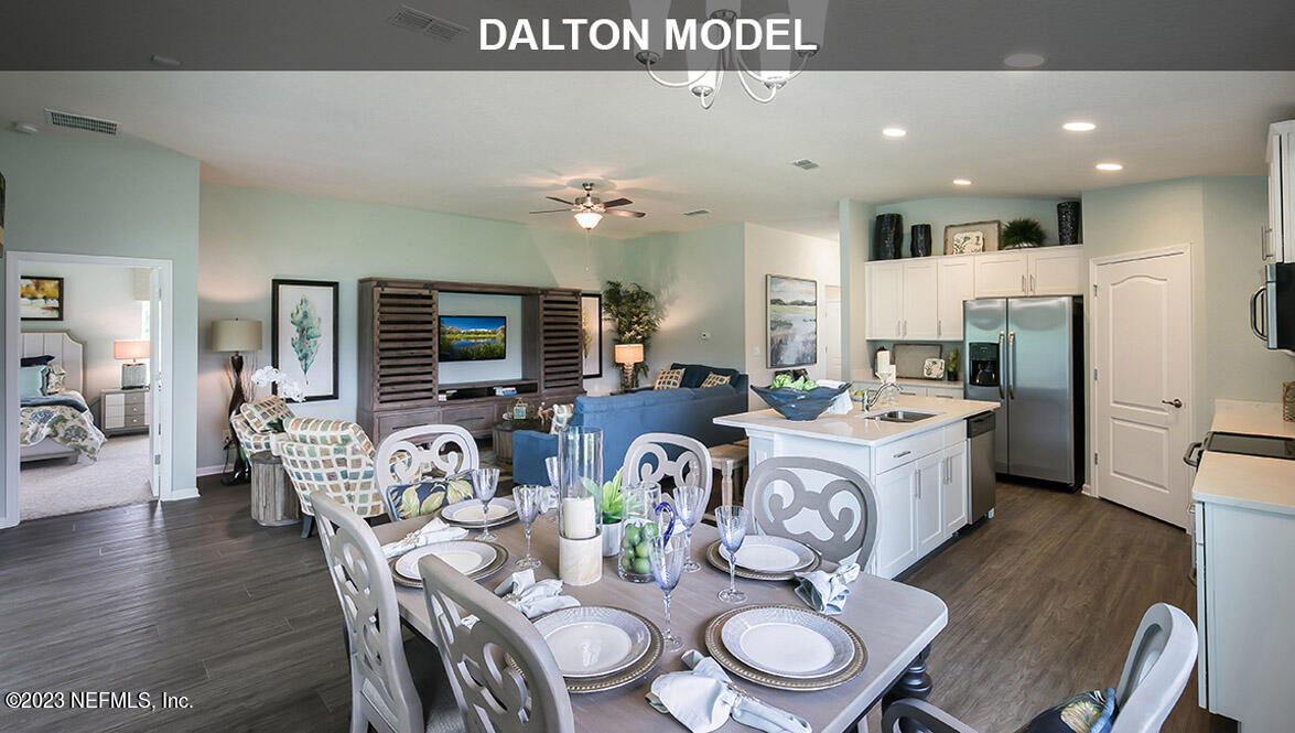 65792 Edgewater Drive Yulee, FL 32097 - Photo 6 of 45 a very nice looking dining room with kitchen island furniture a chandelier and a view of kitchen
