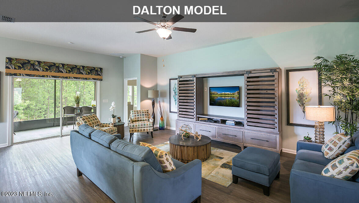 65792 Edgewater Drive Yulee, FL 32097 - Photo 7 of 45 a living room with furniture and a flat screen tv