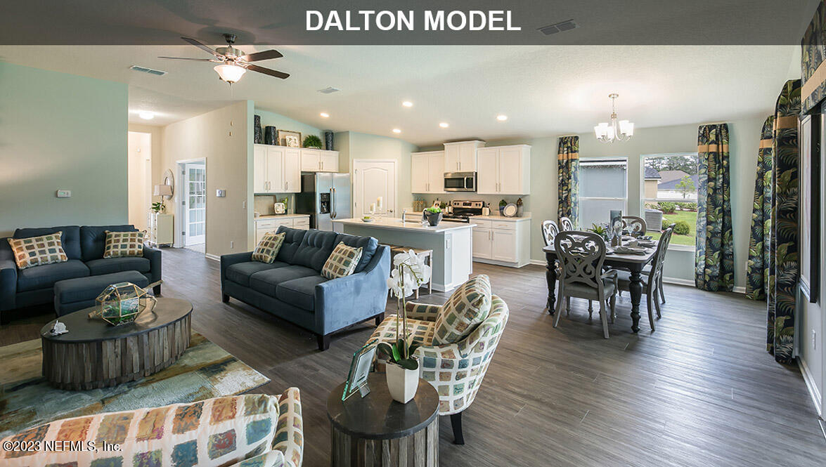 65792 Edgewater Drive Yulee, FL 32097 - Photo 8 of 45 a living room with furniture kitchen view and a wooden floor