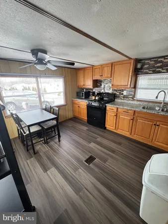 a room with wooden floors table and chairs