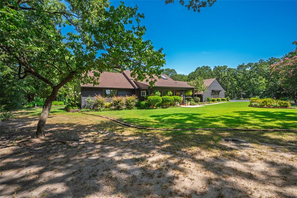 1516 Rancho Road Quinlan, TX 75474 - Photo 38 of 40 a view of a house with a yard