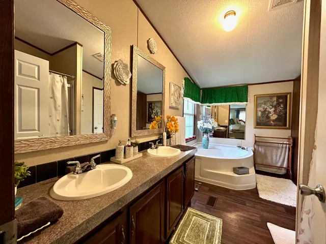 a bathroom with a granite countertop sink mirror vanity and toilet