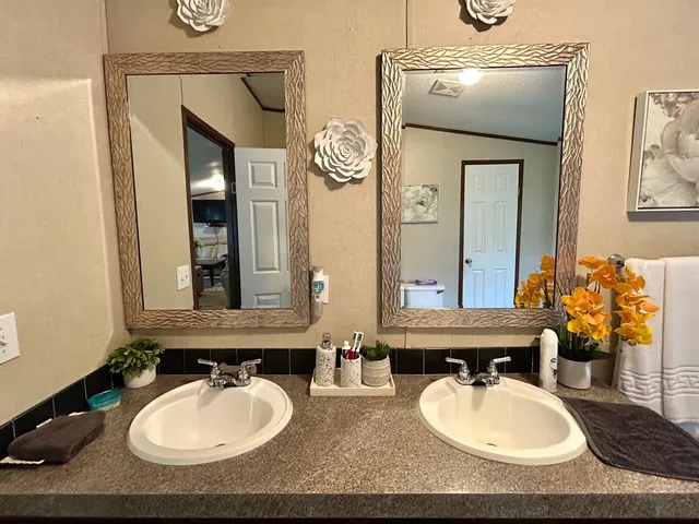 a bathroom with 2 sink and a mirror