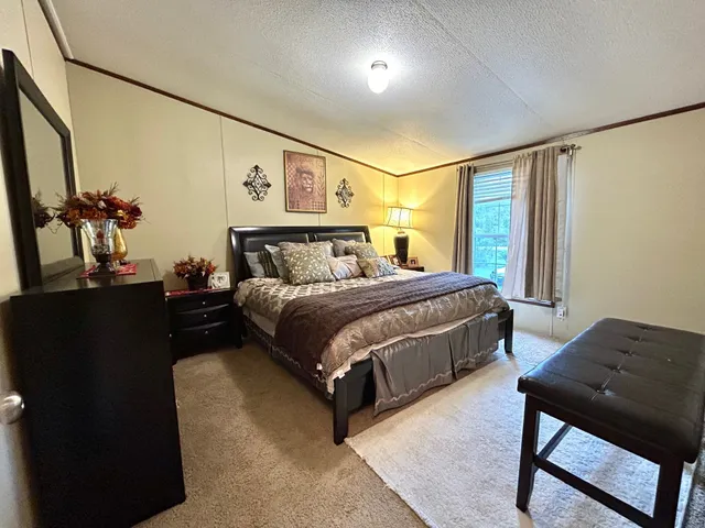 a bedroom with a bed lamps and a mirror