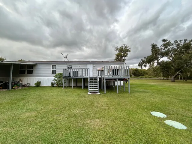 a view of a house with yard and sitting area