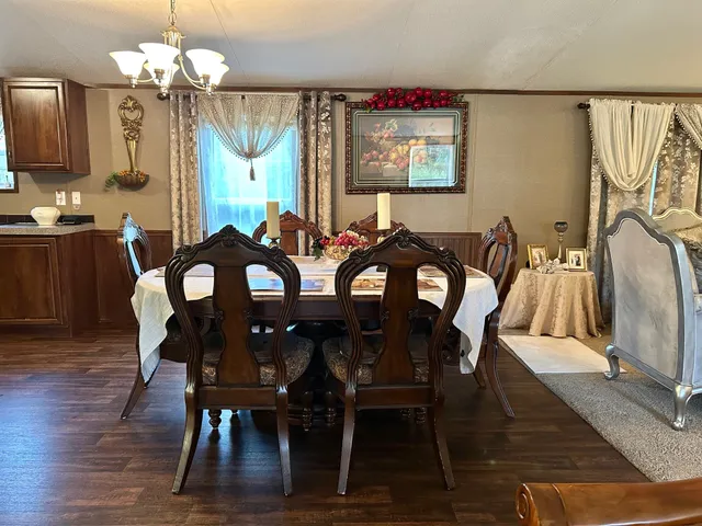 a view of a dining room with furniture and chandelier