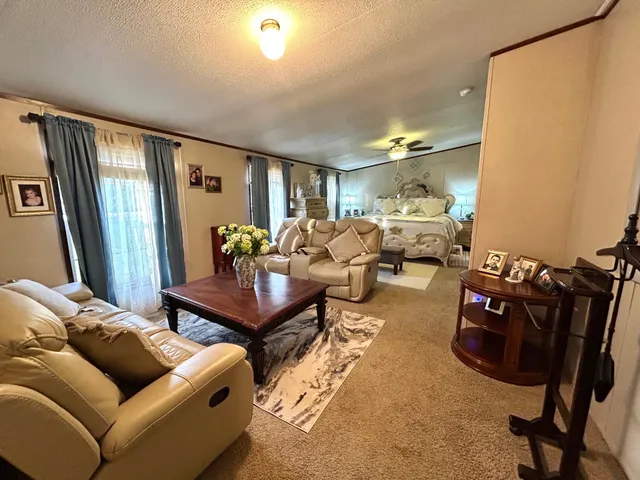 a living room with furniture a rug and a flat screen tv