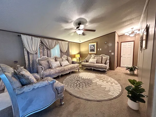 a living room with furniture and a chandelier
