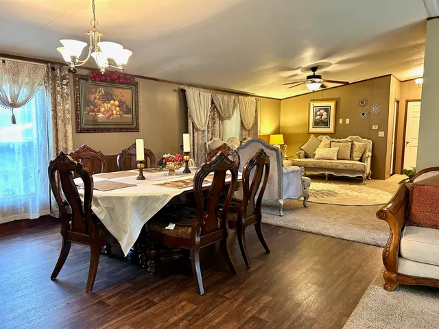 a view of a dining room with furniture wooden floor and chandelier
