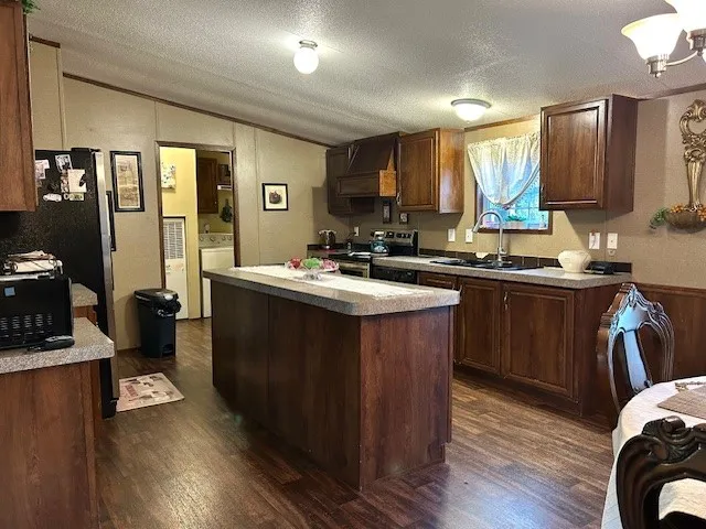 a kitchen with a sink appliances and cabinets