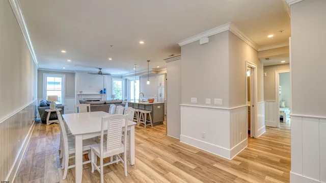 a large white kitchen with a table and chairs