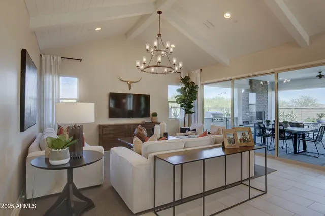 a living room with furniture and a chandelier