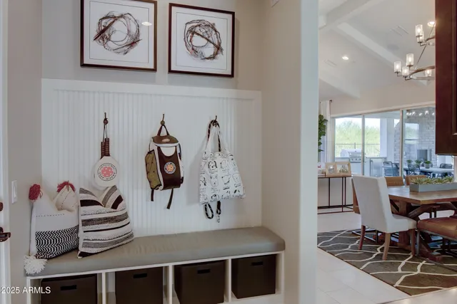 a living room with furniture kitchen view and a chandelier