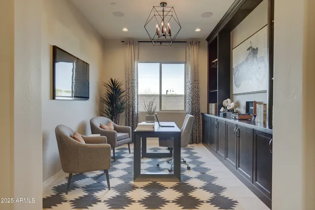 a view of a dining room with furniture and many windows