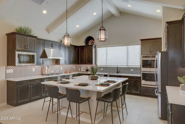 a kitchen that has a table and chairs in it