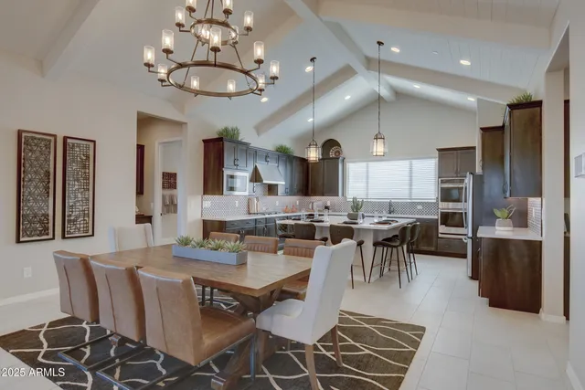 a kitchen with a sink and chairs