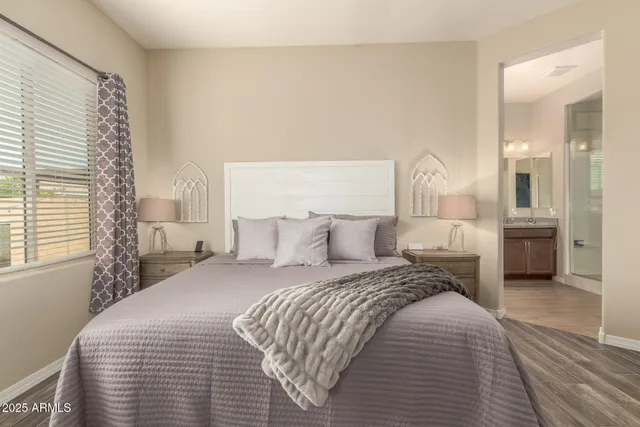 a bedroom with a bed and a flat screen tv