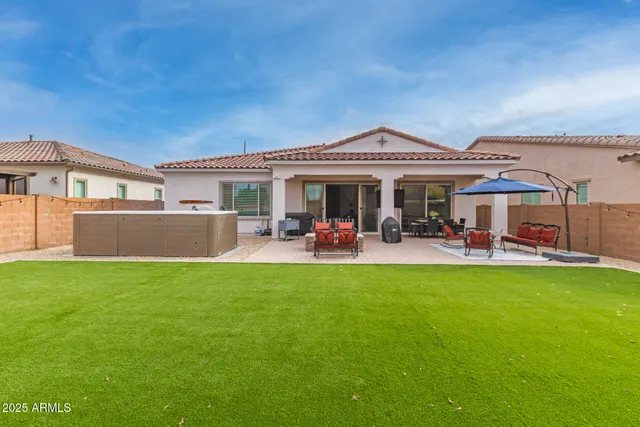 a view of backyard with swimming pool and furniture