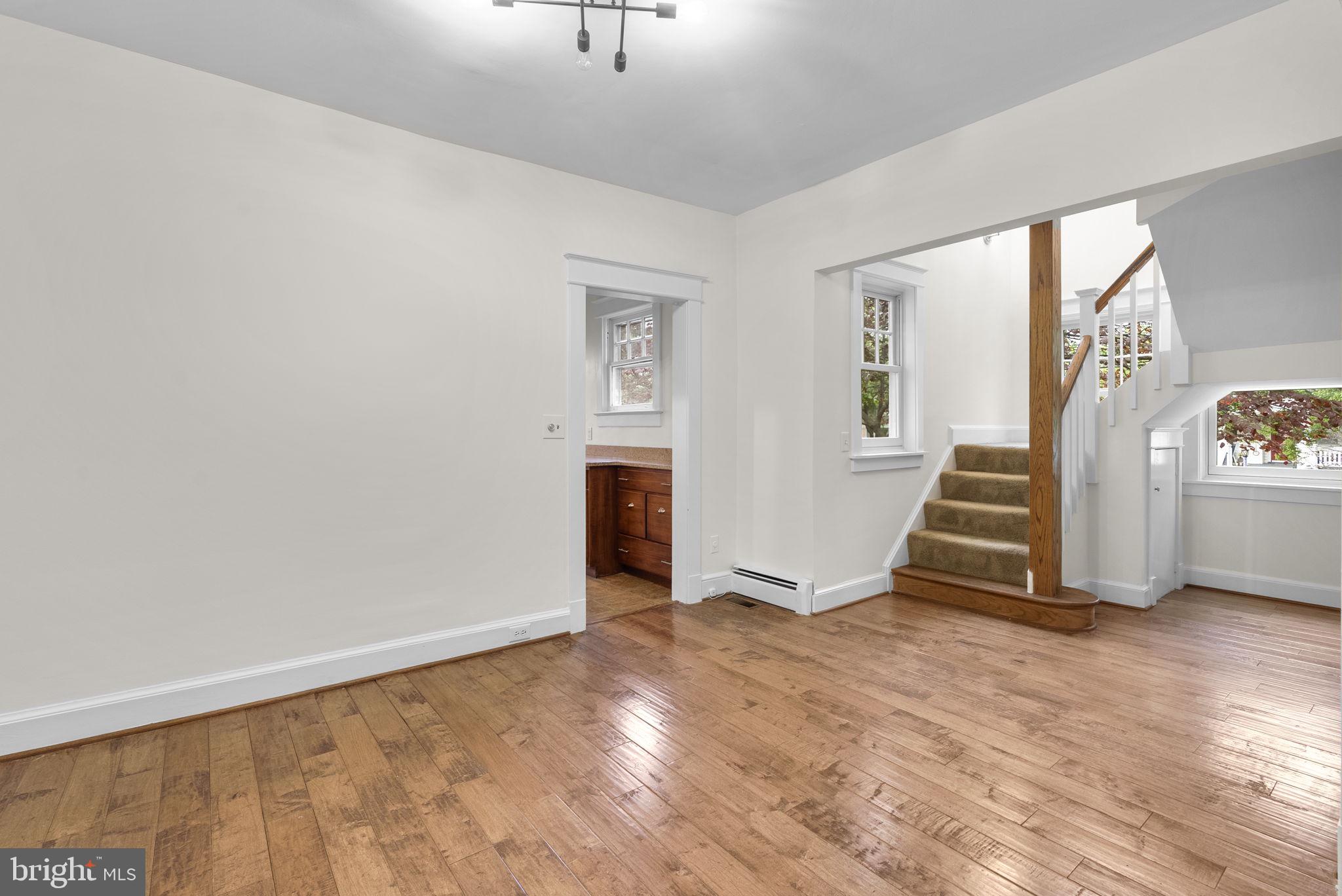 9120 Glenridge Road Silver Spring, MD 20910 - Photo 7 of 59 a view of an empty room with wooden floor and a window