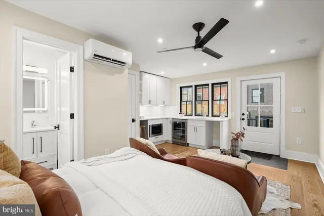 a bedroom with a bed furniture and a large window