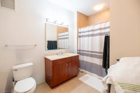a bathroom with a sink toilet and mirror