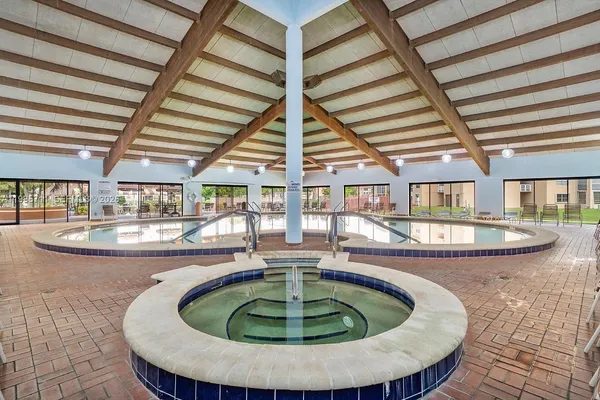 a view of a swimming pool with seating space